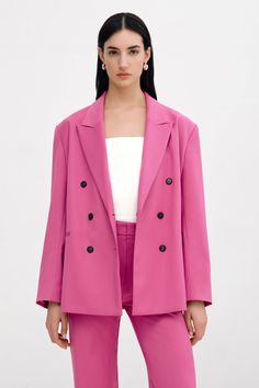 Harmoniously relaxed and structured, our Hannah Blazer is your next nine-to-wine staple. This boxy, long-sleeve blazer features a peak lapel collar, double welt pockets, and a center-back slit. She’s fully lined and tailored from soft, European polyviscose, with bold padded shoulders and versatile double-breasted buttons to complete her confident silhouette. | Emily, in hot pink, is 5'9.5" (177 cm) tall, wearing size XS. Astrid, in light grey, is 5'9" (175 cm) tall, wearing size XS. Yada, in light grey, is 5'9" (175 cm) tall, wearing size XS. Sejal, in black, is 5'8" (173 cm) tall, wearing size M. Bianca, in black, is 5'8.5" (174 cm) tall, wearing size XS. Total length is approximately 28.5" (73 cm).European Polyviscose (66% Viscose, 31% Polyester, 3% Elastane). 100% Viscose lining. Machin Hot Pink Blazers, Peak Lapel, Pink Blazer, Fitted Blazer, Long Sleeve Blazers, Double Breasted Blazer, Sweater Pants, Distressed Leather, Grey Women