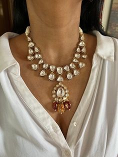 All our pieces are in stock and will be dispatched within 24 to 48 hours of order. Orders received during the weekend will be dispatched on Monday One of our favorite picks for the wedding season ❤️ The Tanjore artwork beads at the bottom of the necklace adds a perfect glamour to the stunning piece. Dimensions Weight of Necklace is 90 g. Drop Length of Necklace: 10 inches Necklace comes with adjustable Dori. Weight of earrings is 16 g per pair. Drop Length of earrings: 4 cms, Push back closure. Heavy Pendant Necklace As A Gift, Kundan Temple Jewelry Gift, Wedding Temple Necklace With Pearl Drop, Kundan Pendant Necklace For Gift, Kundan Pendant Necklace For Gifting, Handmade White Temple Jewelry Bridal Necklace, Traditional Teardrop Necklace For Gift, Elegant Bridal Necklace With Tilla Pendant, Handmade White Bridal Temple Jewelry Necklace