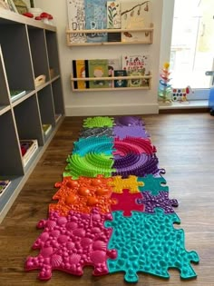 the colorful rug is on the floor in the children's playroom, and it looks like they have been made out of legos