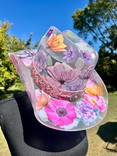 This is a wearable hat. If you're looking for a show stopping piece, something incredibly unique, and one of a kind, this is the one! It's the same size as my standard one size hats, however because it's acrylic, no adjustable tie to make size smaller. Flowers are these beautiful fine line stickers and all greenery is hand painted. It's all coated in a think layer of resin to protect design. Custom Wide Brim Multicolor Hat, Custom Multicolor Wide Brim Hat, Custom Multicolor Brimmed Hat, Custom Multicolor Hat With Curved Brim, Unique Hat For Rodeo And Kentucky Derby, Unique Hats For Kentucky Derby, Unique Hats For Kentucky Derby And Country Events, Whimsical Hat For Kentucky Derby, Unique Curved Brim Hat For Spring