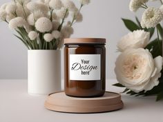 there is a jar with a label on it next to some flowers and a vase