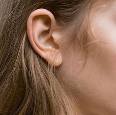 a woman's ear is shown in close up