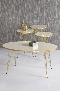 three tables sitting on top of each other in front of a wall