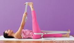 a woman is laying on the floor with her legs in the air while using a yoga mat