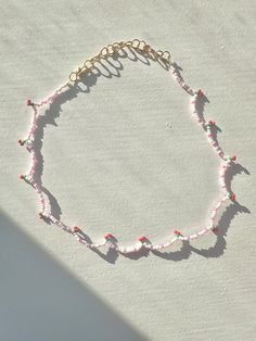 🍒 Cute and dainty light pink beaded necklace with red cherries. 🌸 This necklace can be worn anywhere in length from 14 to 17 inches, making it adjustable to fit any occasion. It closes with a lobster clasp and has an extender of 2.5 inches. 🍒 The extender and lobster clasp are gold plated. 🌸 This necklace is handmade carefully. To preserve it, avoid wetting it. Pink Dainty Necklace With Beaded Chain, Dainty Pink Beaded Necklaces For Gifts, Dainty Pink Beaded Necklaces For Summer, Dainty Pink Beaded Necklace For Gift, Pink Beaded Necklace For Summer Gifts, Trendy Adjustable Pink Beaded Necklaces, Trendy Pink Adjustable Beaded Necklaces, Trendy Pink Adjustable Beaded Necklace, Cute Pink Summer Necklaces