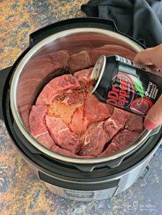 someone is pouring coke into an instant pot filled with raw meat