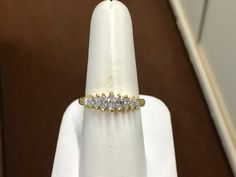 "The item is a 18 k yellow gold marquise diamond ring. The ring consists of nine marquise shaped diamonds that graduate in size from 5 x 2.5 millimeters down to 2.5 x 1.5 millimeter. The total carat weight of the diamonds is 0.65 carats. The diamonds have a \"H\" color and an \"SI 1\" clarity grading. Each diamond is held in with two prongs. The ring is a finger size 8 and I can size it for you at no charge. The ring weighs 4.8 grams. I will provide a ring box. I can also provide a free written Formal Marquise Cluster Ring With Vvs Clarity, Classic Marquise Yellow Gold Cluster Ring, Gold Marquise Diamond Promise Ring, Classic Marquise Diamond Ring With Vs Clarity, Marquise Diamond Ring With Vs Clarity For Anniversary, Gold Marquise Cluster Ring With Brilliant Cut, Marquise Diamond Ring In Yellow Gold With Vs Clarity, Gold Marquise Diamond Ring With Vvs Clarity, Gold Cluster Ring With Vvs Clarity Marquise Cut