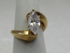 a gold ring with an oval cut diamond