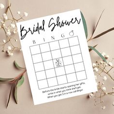 the bridal shower game is next to flowers and greenery on a pink background