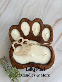 a dog paw candle holder with candles inside