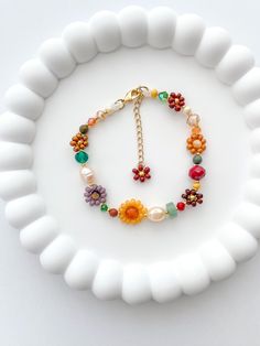 The MARIGOLD beaded bracelet has a bohemian and timeless style. Inspired in the fall season it's the perfect gift for any woman, friend, sister, daughter, etc. 100% handmade using the best materials.  FEATURES:  * Seed beads sizes 2 to 4mm, freshwater pearls 5-7mm, natural stones 4-6mm, and crystals 6-4mm. * 18k Gold Plated Lobster clasp and findings. * Made with love and care. LENGHT: Choose between 6.5 or 7 inches + Each bracelet comes with a 1 inch extender chain CARE INSTRUCTIONS: *Remove be Stone Breslate, Fall Bead Bracelet Ideas, Diy Flower Bracelet With Beads, Handmade Bohemian Bracelets, Diy Christmas Gifts Friends, Handmade Beads Bracelet, Fall Beaded Jewelry, Fall Beaded Bracelets, Bracelet Beads Ideas