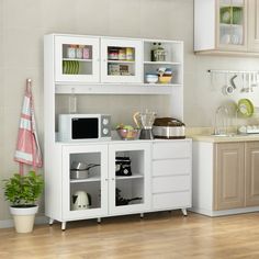 a kitchen with white cabinets and wooden floors