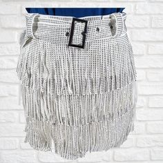 "No filter is needed, it sparkles just as bright as your soul does!  95% POLYESTER, 5% SPANDEX Color: White Fringe Skort Pewter Rhinestone Embellishments Matching Belt Back Zipper Closure Tiered Design Skirt Overlay With Shorts Lining Skort Has Some Stretch 16\" Waistband To End Of Fringe 2\" Inseam *Screen resolution, lighting may alter item color or design and brightness. Sizing- Small: 2-4 | Waist: 30 inches Hips: 35 inches Length: 14 inches Medium: 6-8 | Waist: 31 inches Hips: 39 inches Length: 14.25 inches Large: 10-12 | Waist: 32 inches Hips: 41 inches Length: 14.50 inches 1XL: 14-16 | Waist: 39 inches Hips: 46 inches Length: 16 inches 2XL: 18-20 | Waist: 41 inches Hips: 48 inches Length: 16.5 inches 3XL: 20-22 | Waist: 43 inches Hips: 50 inches Length: 17 inches ☆Returns & Exchanges Trendy White Party Skirt, Trendy White Party Mini Skirt, Trendy White Mini Skirt For Party, White High-waisted Party Skort, White High Waist Party Skort, White High Waist Skort For Party, Trendy White Festival Bottoms, Trendy White Skirt For Night Out, White Mini Skort For Party