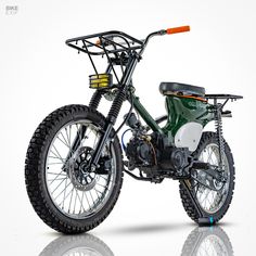 a green dirt bike parked on top of a white floor