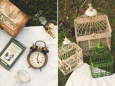 there are two bird cages and an alarm clock on the table