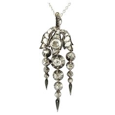 This marvelous Georgian era pendant has been crafted of solid 12 Kt gold topped by silver Fascinating "En Tremblant” trembling suspended pendeloques typical of the Georgian era, 1780 ca Adorned with white sparkly rose cut Diamonds for approx 1.30 Ct by the spread Diamonds are close back set Measuring 47 x 16 mm. (h. x w.) Lovely condition Great addition at any collection Unless otherwise stated boxes are for presentation only Further Details Below Metal: 12 Kt gold and silver, tested Hallmarks: none/worn Gems: 26 rose cut diamonds totaling approx 1.30 Ct (by spread) Measures: 47 x 16 mm. (h. x w.) Weight: 5.8 grams Condition: very good commensurate to age and use Georgian Era, Gold Top, Rose Cut Diamond, Gold And Silver, Rose Cut, Silver Pendant, Silver Gold, Jewelry Necklace Pendant, Diamond Cuts