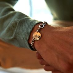 Our slender box chain bracelet is made from sleek sterling silver and secured with a hinged hook for added elegance. But the real treasure? A smooth coin embossed with an eye motif designed to ward off evil spirits. #materials sterling silver, 4mm wide, Handcrafted, Designed in NYC Tarnish Resistant Silver Chain Bracelet In Sterling Silver, Sterling Silver Tarnish Resistant Bracelet, Tarnish Resistant Sterling Silver White Gold Chain Bracelet, Sterling Silver White Gold Chain Bracelet, Tarnish Resistant White Gold Sterling Silver Bracelet, Timeless Silver Brass Jewelry, Everyday Spiritual Engraved Bracelets, Timeless Engraved Sterling Silver Bracelet, Adjustable Round Box Chain Bracelet