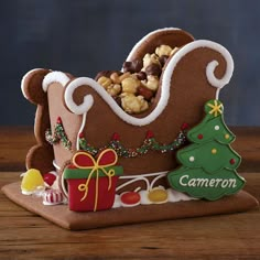 a gingerbread christmas sleigh filled with nuts and candy