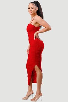 a woman in a red dress posing for the camera with her hands on her hips