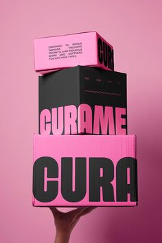 Curame is a high-quality hair care brand dedicated to restoring and  revitalizing all hair types. With a vibrant and youthful aesthetic characterized by bold pink and black colors, Curame offers a range of nourishing shampoos, oils, hair masks, and many more. The products are designed to repair damage, promote growth, and enhance shine and softness, all while maintaining a clean, sleek, and fun image. Black And Pink Packaging Design, Inside Packaging Ideas, Branding And Packaging Design, Hair Wax Packaging Design, Hot Pink Graphic Design, Pink Black Branding, Packaging Design Trends 2025, Edgy Packaging Design, Affordable Packaging Ideas