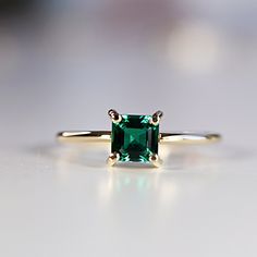 "This beautiful Emerald Gold Ring was handmade in Melt'm Jewelry Design Studio in California using 14k solid yellow gold band and 5x5mm asscher cut lab grown emerald stone. Emerald is featuring in 14k gold prong setting. DETAILS ABOUT THE RING, MATERIAL AND STONES Ring Band: 14K YELLOW GOLD Ring Band size: 1 mm thick Gemstone: Lab grown Emerald Emerald size: 5mm x 5mm asscher cut AAA quality It is a great birthday gift for your special ones whose birthday are in May, since Emerald is May birthst 14k Gold Emerald Ring Princess Cut, 14k Gold Princess Cut Emerald Ring, 14k Gold Asscher Cut May Birthstone Ring, Square Cut Emerald Rings In Gold, Square Cut Emerald Gold Rings, Gold Asscher Cut Emerald Ring For May Birthstone, Gold Emerald Rings With Asscher Cut, Asscher Cut Gold Emerald Ring For May Birthstone, Emerald Ring In 14k Yellow Gold With Square Cut