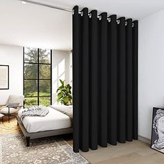 a bedroom with a bed, chair and window curtain in grey color on the wall