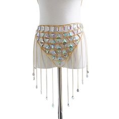 Introducing the Glam Tassel Chain Set - a dazzling and trendy two-piece outfit designed for fashion-forward women. This set is perfect for festivals, parties, or any occasion where you want to stand out in style. Featuring a stunning chain crop top, this set is adorned with crystal sequins and handmade patchwork for a unique and eye-catching look. The metal tassel chains add a touch of glamour and movement, creating a mesmerizing effect as you dance the night away. Crafted with attention to deta Glamorous Crystal Body Jewelry For Festivals, Glamorous Festival Body Jewelry With Crystal, Glamorous Festival Crystal Body Jewelry, Glamorous Festival Body Jewelry In Crystal, Gold Waist Chain For Summer Festivals, Metal Body Chain For Summer Festivals, Glamorous Rhinestone Body Jewelry For Festivals, Glamorous Festival Body Jewelry With Bling, Summer Festival Metal Body Chain