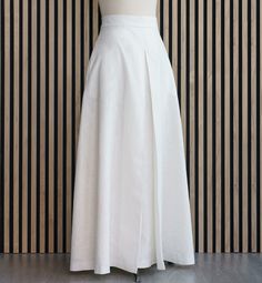 Long linen skirt with pockets and high waistband in ecru. The A-line skirt is a wide skirt perfect for special occasions. It has a nice pleat on the front. Skirt with cotton lining.  Skirt length: 110 centimeters                        43,3 inches Care recommendations: Cold water washing (no more than 30 degrees Celsius) is preferred, as well as machine washing in delicate mode. Use mild detergents. Don't use bleach. Do not tumble dry. White A-line Cotton Maxi Skirt, White Cotton A-line Maxi Skirt, A-line Pleated Skirt With Pockets, White A-line Gathered Skirt, White A-line Skirt, Relaxed A-line Pleated Skirt With Pockets, White A-line Lined Skirt, White Relaxed A-line Skirt, White Pleated A-line Skirt