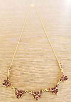 "This is an antique garnet and gold flower necklace. It is marked \"333\" on the closure for 8k gold. This piece is in excellent vintage condition. This necklace measures 17 inches." Formal Yellow Gold Garnet Necklaces, Formal Yellow Gold Garnet Necklace, Gold Garnet Birthstone Necklace, Victorian Garnet Necklace, Vintage Garnet Gemstone Necklace, Victorian Brown Necklace For Gift, Gold Garnet Necklace For Wedding, Victorian Garnet Necklace For Gift, Victorian Garnet Necklace Gift