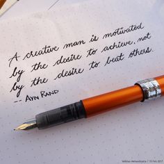 a fountain pen sitting on top of a piece of paper that has writing on it