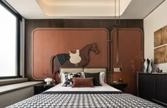 a bedroom with a horse head mounted to the wall above it's bed, along with other furniture and decor