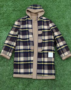 Not only is this Lumberjack Jacket the perfect winter coat, but it is super unique, rare, and is also reversible. @ Jackets in one! If you're looking for the perfect jacket to take camping, to wear out for a special occasion, or to subtly stand out; then this is the jacket for you. The jacket has a tan wool exterior, and a yellow, black and white plaid interior. It is made from wool, with leather ans deer antler duffel buttons.  This jacket also has a beautiful large hood, 2 front pockets, antle Retro Brown Outerwear For Cold Weather, Retro Long Coat For Fall, 70s Camping, Retro Brown Hooded Outerwear, 70s Plaid, Vintage Hooded Outerwear For Fall, Antler Buttons, Retro Brown Winter Outerwear, Duffel Coat