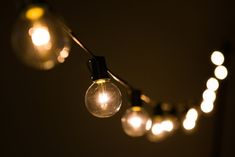 several light bulbs are hanging from a string