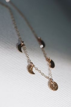 A minimalist dainty piece that you can wear every day, lovely on its own or layered with other necklaces. Each moon is unique, with the prettiest hand hammered texture.  The moon phases are a sweet representation of the passage of time, and the seasons of our life waxing and waning. To me the five little moons represent my little babies, which feels especially sweet to me as I leave the baby phase and enter a new phase with them. Time is fleeting and these little moons remind me to enjoy every changing second. Made with solid sterling silver, gold filled, or rose gold filled chain and moons. Each moon is placed 0.75 inches apart. It can be worn at 16 inches (or clasped directly on the chain to wear however short you'd like) up to 20 inches. The shorter length makes it the perfect gift for Time Is Fleeting, Matching Mommy Daughter, Moon Necklace Silver, Moon Phases Necklace, Necklace Extender, Mother Rings, Pretty Hands, Crescent Moon Necklace, Short Necklace