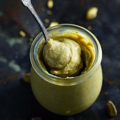 a spoon in a jar filled with food