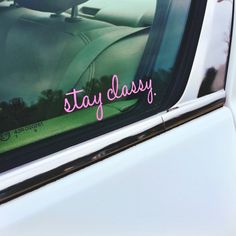 a sticker that says stay classy on the side of a white car window