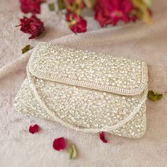 Featuring a Silver Clutch bag in cotton base with a flap opening with a embroidererd strap, Handcrafted with Intricate Pearl, beaded crystal and rhinestones.  Perfect for evening parties and a special ocassion.  This item made of is 100% handwork We try to take pictures as normal as we can but colors may slightly vary due to different lighting setups. Please note: No Returns No Exchange. But If you have any issue with your order, Kindly contact us before leaving a review Wedding Clutch Bag With Mirror Work, Festive White Rectangular Clutch, Festive Wedding Bag With Mirror Work, Rectangular Hand Embellished Wedding Bag, Festive Wedding Bags With Mirror Work, Rectangular Embroidered Shoulder Bag For Celebration, Embroidered Rectangular Shoulder Bag For Celebration, White Rectangular Celebration Bags, Festival Wedding Bags With Mirror Work