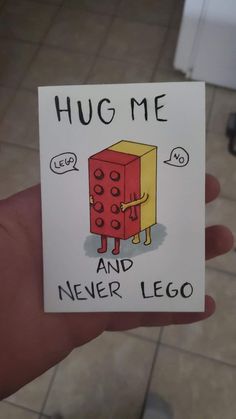 someone is holding up a card that says hug me and never lego