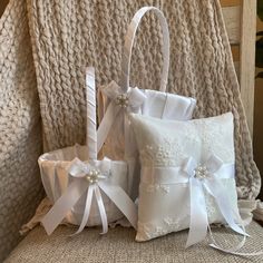 three white wedding baskets with bows and ribbons