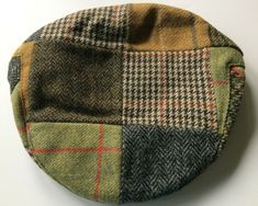 These traditional flat caps were made in County Cork, Ireland by Shandon Hats.   They are made from tweed wool and are fully lined.   They are all in the same mixture of tweeds but the placement of the patches may differ from the picture.  The brim is attached to the hat with a snap / press fastener.   See the chart for your best size.  Shandon Hat and Cap Size Measurements Size Chart Small Medium Large XL 2XL Head Size 6 7/8 7 1/8 7 1/4 7 1/2 7 3/4 Inches 22 22 3/4 23 1/4 24 24 3/4 Cm 56 58 59 61 63 Multicolor Flat Cap For Fall, Irish Flat Cap, Irish Hat, Irish Tweed, County Cork Ireland, County Cork, Flat Caps, Cork Ireland, Flat Cap