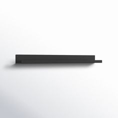 a black shelf sitting on top of a white wall