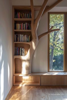 an empty room with bookshelves and a tree in the corner that is made out of wood