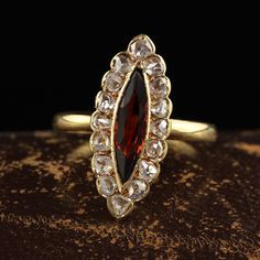 Beautiful Antique Victorian 18K Yellow Gold Rose Cut Diamond and Garnet Navette Ring. This gorgeous antique Victorian navette ring is crafted in 18k yellow gold. This ring features a marquise shaped garnet in the center with rose cut diamonds around it. The stones are set in a low profile Victorian setting and is in great condition. Item #R2034 Metal: 18K Yellow Gold Weight: 3.8 Grams  Size: 8 Garnet: Approximately .80 cts Diamonds: Approximately .50 cts Color: I Clarity: SI2 Measurements: Top of the ring measures 22.07 mm wide and band measures 1.77 mm wide. Measurements off the finger: 5.04 mm high Layaway: For your convenience, we will be happy to provide layaway payment options. Please contact us to work out a layaway plan which best suits your needs. All layaway purchases are final sa Navette Ring, Rose Cut Diamond, Jewelry Lover, Antique Victorian, Rose Cut, Gold Rose, Low Profile, Halloween Shopping, Garnet