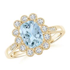 a ring with an aqua blue stone surrounded by white and clear diamonds on the band