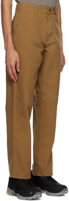 Relaxed-fit 12 oz organic cotton canvas trousers. · Belt loops · Five-pocket styling · Zip-fly · Utility pockets · Hammer loop · Textile logo patch at back Supplier color: Hamilton brown Canvas Pants, Fly Logo, Carhartt Work In Progress, Men Carhartt, Utility Pockets, Textile Logo, Carhartt Mens, Casual Trousers, Cargo Trousers