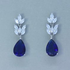 "Sapphire blue crystal earrings will beautifully fill your order of 'something blue' for you or your girls. Designed with marquise shaped crystals in a segmented style for lovely movement and create such sparkle! We finished them with a beautiful teardrop for a great mid-length earring. 'Sandra' will have all eyes on you. Why not treat yourself or your bridesmaids, or both! ❣ Earring length is 1.5\". ❣ Highest-quality cubic zircons set in tarnish-resistant 18K rhodium for heirloom quality. ❣ Nic Blue Sapphire Pear-shaped Earrings, Blue Crystal Drop Earrings For Formal Occasions, Elegant Blue Drop Crystal Earrings, Blue Dangle Crystal Earrings For Formal Occasions, Blue Pear-shaped Teardrop Earrings For Formal Occasions, Elegant Blue Drop Bridal Earrings, Blue Bridal Earrings For Formal Occasions, Formal Blue Crystal Earrings, Blue Drop Bridal Earrings For Formal Events