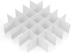 several white plastic blocks arranged in the shape of a snowflake on a white background