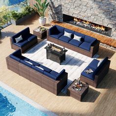 an outdoor living room with blue couches and fire pit in the middle of it