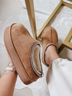 Step up your cozy game with our Cabin Cozy Tan Platform Slip-Ons! These stylish slippers feature a soft, plush interior lining for ultimate comfort, a thick supportive foam insole, and a sturdy, non-slip sole for added safety. The reinforced stitching detail and convenient slip-on style make these perfect for any occasion. Plus, the breathable inner lining and black & white upper stitching detail add a touch of style to these comfortable and functional slippers. So why settle for boring, when yo Platform Slip Ons, Men Workwear, Twisted X Boots, Hey Dudes, Headband Jewelry, Toe Shoes, Shoes Booties, Waterproof Boots, Boots For Sale