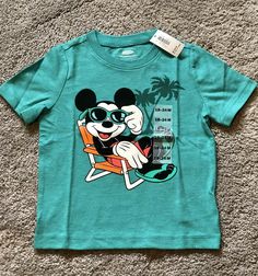 Brand new with tags. Toddler Baby Boys Old Navy Collectabilitees Tee Shirt. Size 18-24 months. Short Sleeves. Teal, turquoise Blue. Disney’s Mickey Mouse beach-themed graphic across front- “Endless Summer” Super soft jersey knit - 50% cotton; 50% polyester Fits children approximately 31-33” and 27-30 lbs. Please see all pictures. FAST FREE SHIPPING- same day or next depending on time of order. Packaged with care. From a clean, smoke-free/pet-free home. No returns. Mickey Mouse 1st Birthday, 1st Birthday Shirts, Teal Turquoise, Beach Themed, Toddler Tees, Baby & Toddler Clothing, Endless Summer, Disney Mickey Mouse, Summer Tshirts